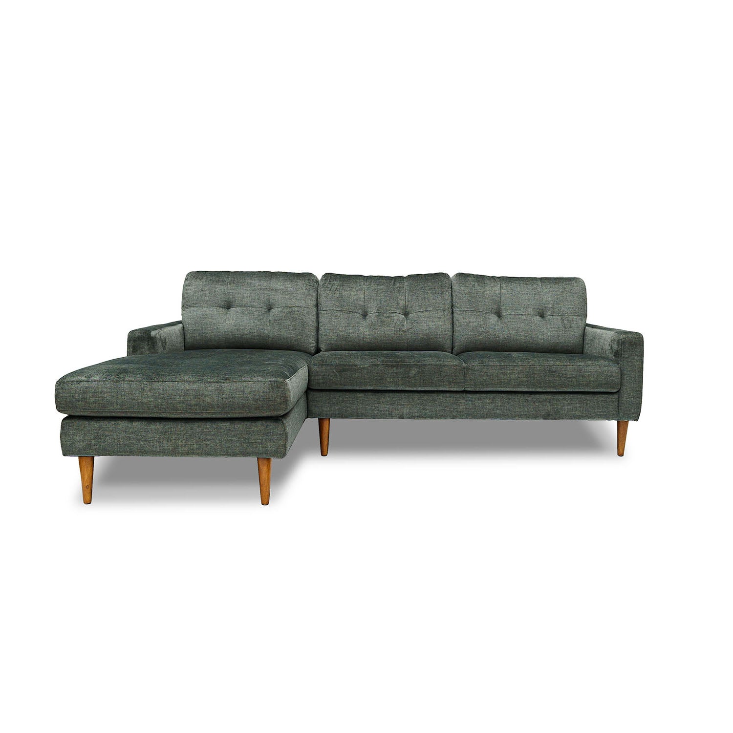 A green velvet modular sofa with a left-side facing chaise lounge, featuring tufted backrest and wooden legs.